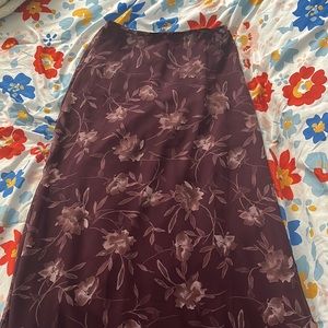 A beautiful purple ish red skirts with gorgeous flowers on it